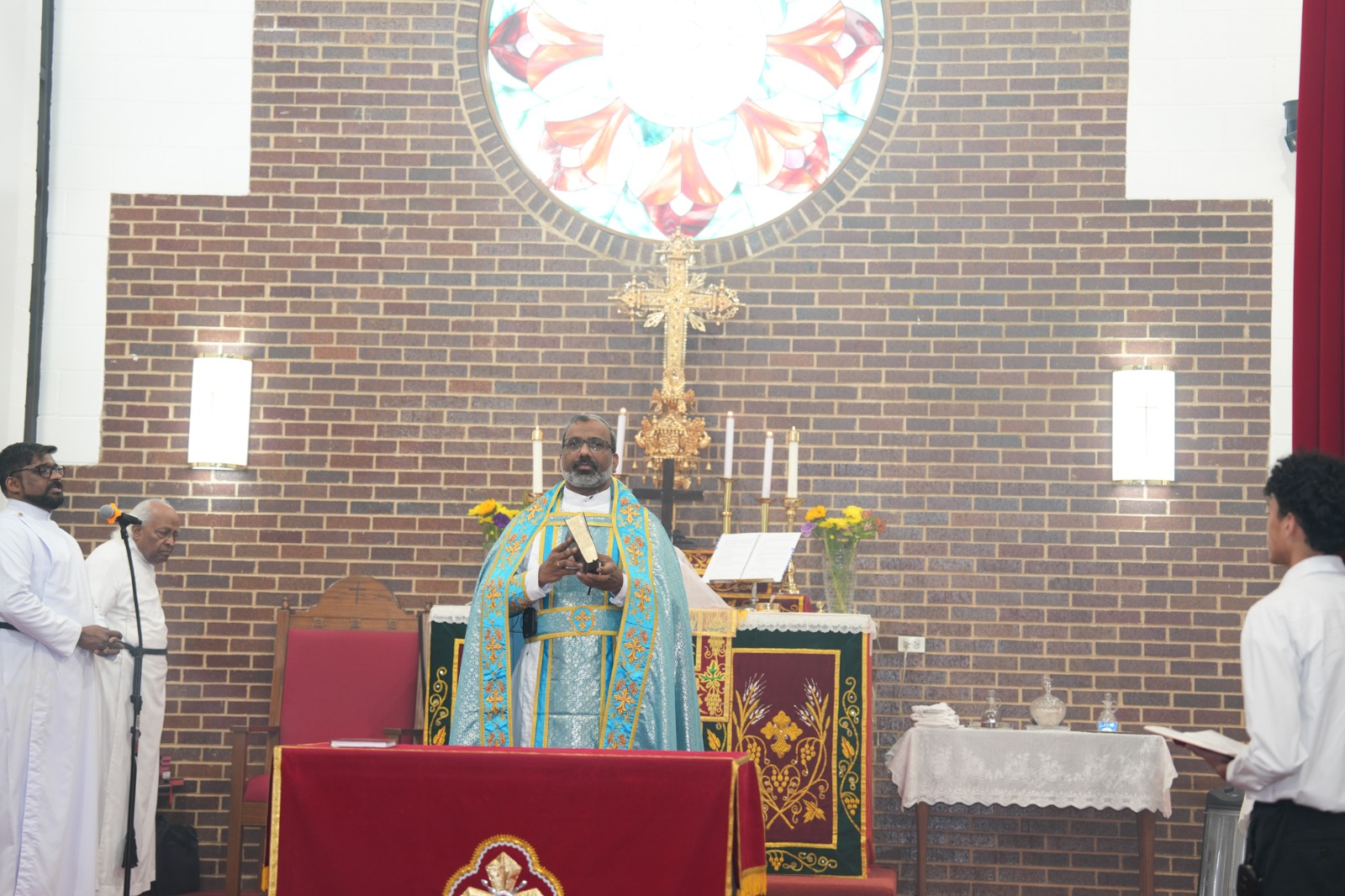 Priest leads Sunday worship at the altar